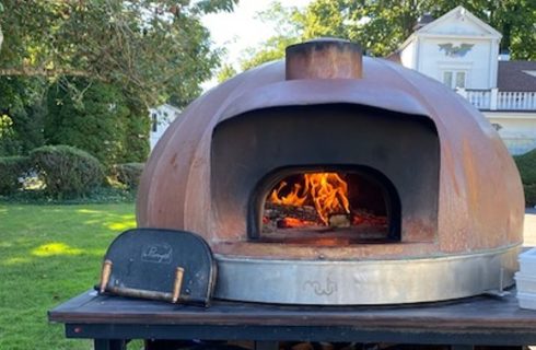 Large round table top wood fired oven outdoors